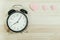 Valentine day background pink heart clock placed on wooden with