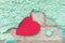 Valentine day background with red paper heart on a rustic green crumbling wall. heart is stuck on the stucco