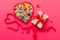 Valentine day composition: sweet candy, with gift boxes with bow and red felt hearts, photo template, background. Top