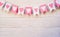 Valentine day concept. white and pink flags hangingon a rope on white rustic background