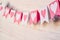 Valentine day concept. white and pink flags hangingon a rope on white rustic background