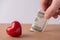 Valentine day wedding profit earnings payment. Cropped closeup photo of man male hand putting banknote into hole