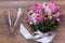 Valentine flowers with wineglass on wooden background