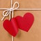 Valentine gift with red heart shape gift tag, brown paper package parcel background