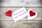 Valentine greeting card on wooden table with text written in spanish Feliz dia de San Valentin, which means Happy Valentine`s day.