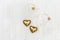 Valentine greeting concept. Two lovely gold vintage heart lie on white wood