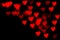 Valentine grunge heart shaped lights background. Red heart-shaped on black background. Red bokeh lights heart