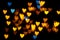 Valentine grunge heart shaped lights background. Yellow gold and blue heart-shaped on black background