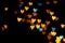 Valentine grunge heart shaped lights background. Yellow gold and blue heart-shaped on black background