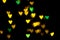 Valentine grunge heart shaped lights background. Yellow gold and green heart-shaped on black background