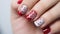 Valentine Nail art manicure with painted hearts and polka dots with copy space.