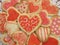 Valentine red, white, and pink iced heart cookies on doily, horizontal #2