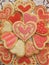 Valentine red, white, and pink iced heart cookies on doily, vertical