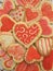 Valentine red, white, and pink iced heart cookies on doily, vertical #2