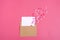 Valentine`s card - envelope, paper for notes, candles in the shape of a heart on a pink background Valentine`s day