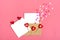 Valentine`s card - envelope, paper for notes, candles in the shape of a heart on a pink background Valentine`s day