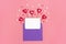 Valentine`s card - lilac envelope, paper for notes, candles in the shape of a heart on a pink background Happy Valentine`