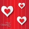 Valentine\'s day abstract applique background with cut red and white paper hearts.