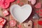 Valentine\'s day background with empty heart shape box on wooden table. View from above