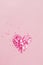Valentine\\\'s Day background February 14th. Heart made of pink hearts confetti on pink background.
