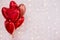 Valentine`s day background - group of red heart shaped balloons over white wall with lights