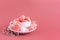 Valentine`s day background with pink french heart-shaped macarons and marshmallows. Cup with macarons and marshmallows