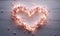 Valentine's day background with pink peach blossoms heart shaped light bulbs