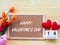 Valentine`s Day Background. Red Heart, 14 February wooden calendar, Flower on Wooden background