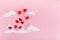 Valentine`s day background. Red hearts, baloons and clouds on soft pink background feel like fluffy in the air