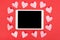 Valentine`s Day background with touchpad and paper hearts. Flat lay.