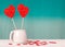 Valentine`s day background. Two lollipops-hearts in a white Cup on a turquoise background, scattering of hearts around