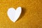 Valentine's Day background. White volumetric paper heart on a golden background. Valentine's Day concept