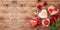 Valentine`s day banner with coffee cup, heart shape chocolate, rose flowers and gift boxes on wooden background