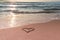 Valentine`s day on the beach. Heart on the beach on the sand. Travel and holidays concept. Space for text