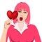 Valentine`s Day. Beautiful girl with pink hair, red lipstick and blue eyes hold red heart.