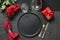 Valentine`s day or birthday dinner. Elegance table setting with red rose on black linen tablecloth