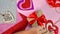 Valentine's Day or birthday presents. Valentine's Day gifts with a red paper heart on a wooden table. Girl makes red