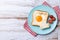 Valentine\\\'s Day breakfast with egg with tomatoes, heart shaped and toast bread on wooden table