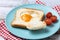 Valentine\\\'s Day breakfast with egg with tomatoes, heart shaped and toast bread on wooden table