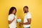 Valentine`s day celebration, happy african-american couple isolated on yellow background