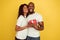 Valentine`s day celebration, happy african-american couple isolated on yellow background