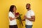 Valentine`s day celebration, happy african-american couple isolated on yellow background