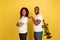 Valentine`s day celebration, happy african-american couple isolated on yellow background