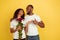 Valentine`s day celebration, happy african-american couple isolated on yellow background