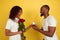 Valentine`s day celebration, happy african-american couple isolated on yellow background