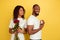 Valentine`s day celebration, happy african-american couple isolated on yellow background