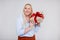 Valentine`s day or christmas concept - portrait of surprised beautiful and elegant plus size blonde woman holding gift box over