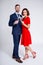 Valentine`s day, christmas and new year concept - full length portrait of beautiful couple posing with glasses of champagne over