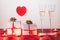 ValentineÂ´s day composition .with two glasses of champagne, heart, gifts .and candles on red background. San Valentin and Love