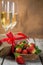 Valentine`s day concept - champagne, strawberry and present